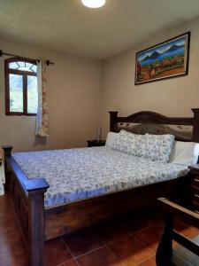 a bedroom with a wooden bed in a room at Hospedaje in San Pablo La Laguna