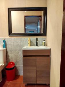 a bathroom with a sink and a mirror at Hospedaje in San Pablo La Laguna +13 photos