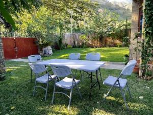 a white table and chairs in a yard at Hospedaje in San Pablo La Laguna