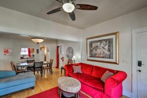 a living room with a red couch and a dining room at Walkable Group Getaway in Bisbee: 4-Unit Bundle! in Bisbee