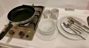 a kitchen counter with a pot and plates and utensils at Sumida Ward - Hotel - Vacation STAY 00237v in Tokyo +2 photos