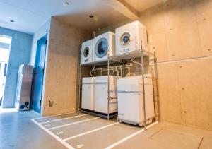 a room with three washing machines and refrigerators in it at Sumida Ward - Hotel - Vacation STAY 00237v in Tokyo