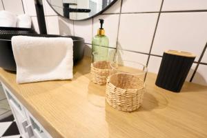 a counter with two baskets and a bottle of wine at St Antoni Suite 4 in Eisenstadt