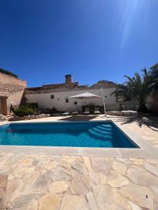 a swimming pool in front of a house at Mirramor in Campo de Mirra