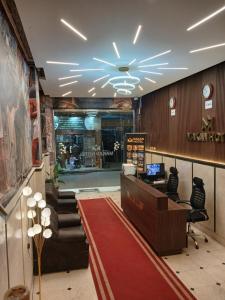 a store lobby with a waiting area with a red carpet at Makan Pyramids View in Cairo