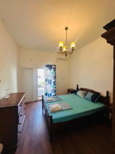 a bedroom with a bed and a chandelier at Blue Maris in Sutomore