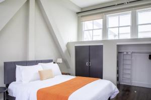 a bedroom with a large bed and a window at Downtown Luxury 1BR Loft · Walkable · Sleeps 4 in Milwaukee +11 photos