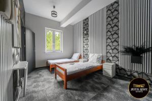 a room with a bed and a chair and a window at Hotel Leśny Korne koło Kościerzyny - Kaszuby in Korne +22 photos