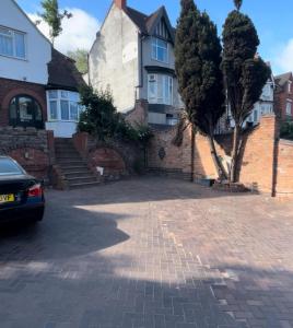 a house with a brick driveway in front of it at Spaghetti House - 6 Bedroom Contractor House Sleeps 12 Parking for 3 Vans Bromford Duddeston Fort Dunlop Star City Saltley Viaduct HS2 in Birmingham