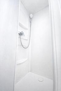 eine Dusche in einem Badezimmer mit Glastür in der Unterkunft The Val Hotel in Châlus