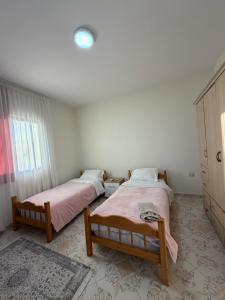 a bedroom with two beds and a window at Hostel Rinas in Rinas