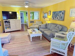 a living room with a couch and a table at Just Peachy in Myrtle Beach