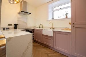a kitchen with a sink and a window at Unique 1 Bed Apartment, Auchterarder in Auchterarder +17 photos