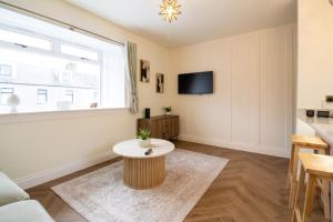 a living room with a couch and a table at Unique 1 Bed Apartment, Auchterarder in Auchterarder