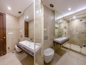 a bathroom with a toilet and a sink and a shower at Hotel The Imperio, Near Apollo Hospital, JASOLA in New Delhi +27 photos
