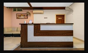 a reception desk in a room with a couch at Hotel Starwood Near Airport Road Sector 78 Mohali Chandigarh in Mohali
