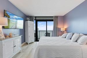 a bedroom with a large bed and a large window at 19th Floor Oceanfront - Panoramic Views - Sleeps 10 - Caribbean Resort in Myrtle Beach