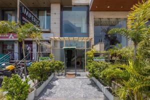 a building in a city with trees and plants at Hotel The Imperio, Near Apollo Hospital, JASOLA in New Delhi