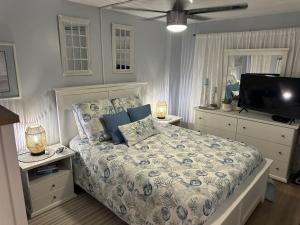 a bedroom with a bed and a flat screen tv at Ocean Front Condo-Beach Front Pool Hottub Elevator in Myrtle Beach +17 photos