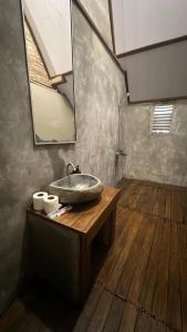 a bathroom with a sink and a mirror at Rice Field and Mountain View House in Karangasem