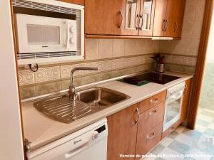 a kitchen with a sink and a microwave at San Gregorio 2 in Soria