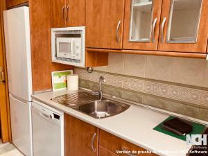 a kitchen with a sink and a white refrigerator at San Gregorio 2 in Soria +11 photos