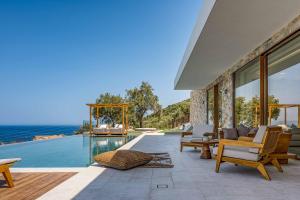 a villa with a swimming pool and a patio at Aurora Thesan in Marathias