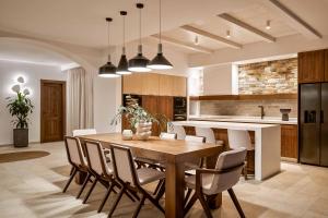 a kitchen with a wooden table and chairs at Aurora Thesan in Marathias +11 photos