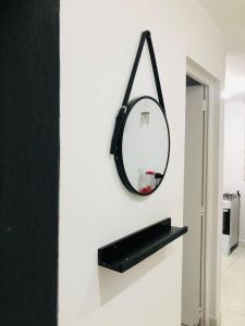 a mirror is hanging on a wall in a room at Casa com piscina in Londrina
