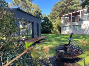 a house with a boat in the yard next to a building at Seamount Design in Mar del Plata