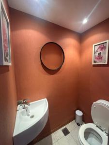 a bathroom with a sink and a toilet and a mirror at Seamount Design in Mar del Plata