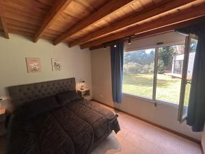 a bedroom with a bed and a large window at Seamount Design in Mar del Plata