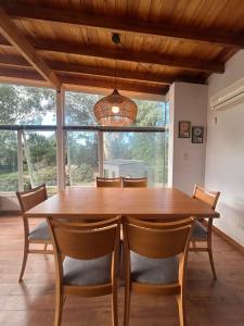 a dining room with a wooden table and chairs at Seamount Design in Mar del Plata