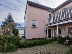 a pink house with a balcony at Landhotel Eisdorf in Eisdorf