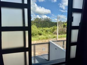 a view from a window of a balcony at Loft Confortável e Tranquilo - Fernandópolis in Fernandópolis