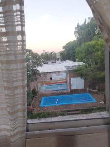 a view of a swimming pool from a window at Casa Garú in Paso de los Libres