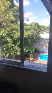a window with a view of a swimming pool at Casa Garú in Paso de los Libres