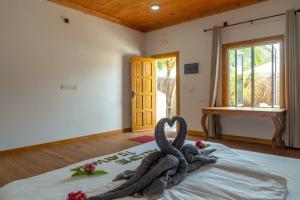a bedroom with a swan decoration on a bed at Ayvana Retreat in Feridhoo