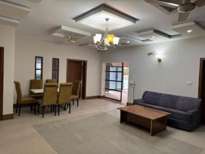 a living room with a couch and a table at Arizona 2 in Islamabad
