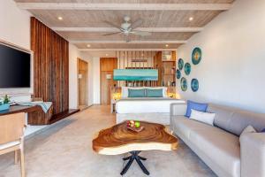 a living room with a couch and a table at Mystique Holbox by Royalton, A Tribute Portfolio Resort in Holbox Island +60 photos