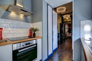 a kitchen with a sink and a stove at Tiffanys Boutique - Coorie Doon Stays in Prestwick