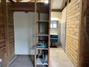 a room with a kitchen with a shelf in it at Ti Bwa in Sainte-Luce