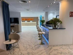 a lobby with a row of chairs and a counter at Hotel Jaime I in Peniscola