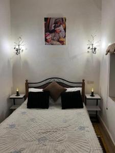a bedroom with a large bed with two night stands at Riad dar khadija in Taroudant