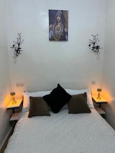 a bedroom with a bed with two side tables at Riad dar khadija in Taroudant