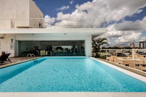 a swimming pool on the roof of a building at Lincoln Suite in Santo Domingo