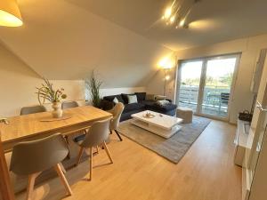 a living room with a table and a couch at Fewo Auenblick in Ascheberg