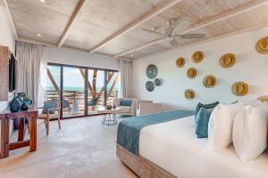 a bedroom with a bed and a view of the ocean at Mystique Holbox by Royalton, A Tribute Portfolio Resort in Holbox Island