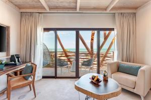 a living room with a view of the ocean at Mystique Holbox by Royalton, A Tribute Portfolio Resort in Holbox Island