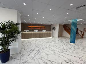 an office lobby with marble flooring and a waiting room at Hotel Jaime I in Peniscola +73 photos
